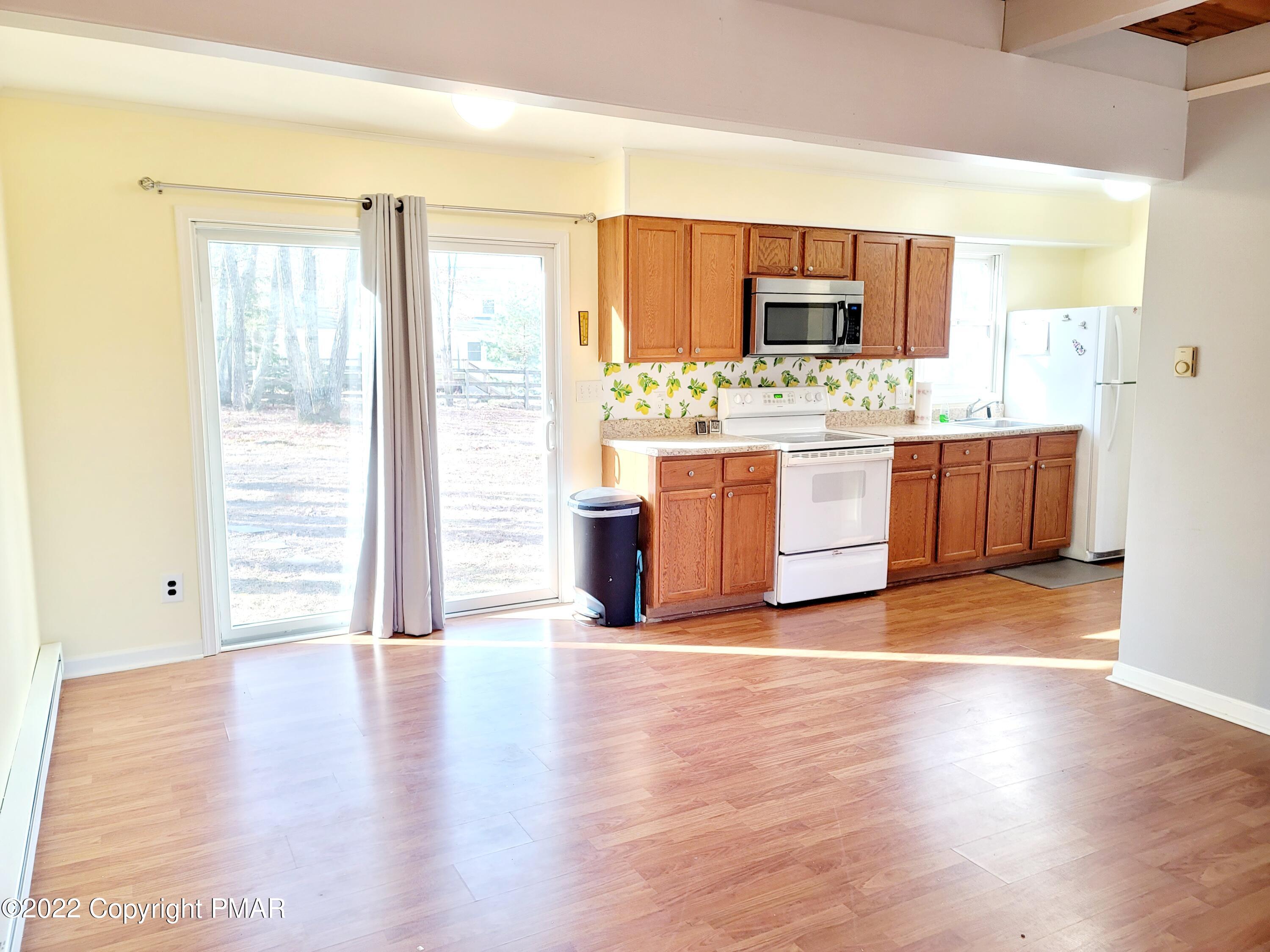 132 Rodeo Drive Hawley, PA 18428 - Photo 5 of 26 a view of a kitchen with kitchen island wooden floors and stainless steel appliances