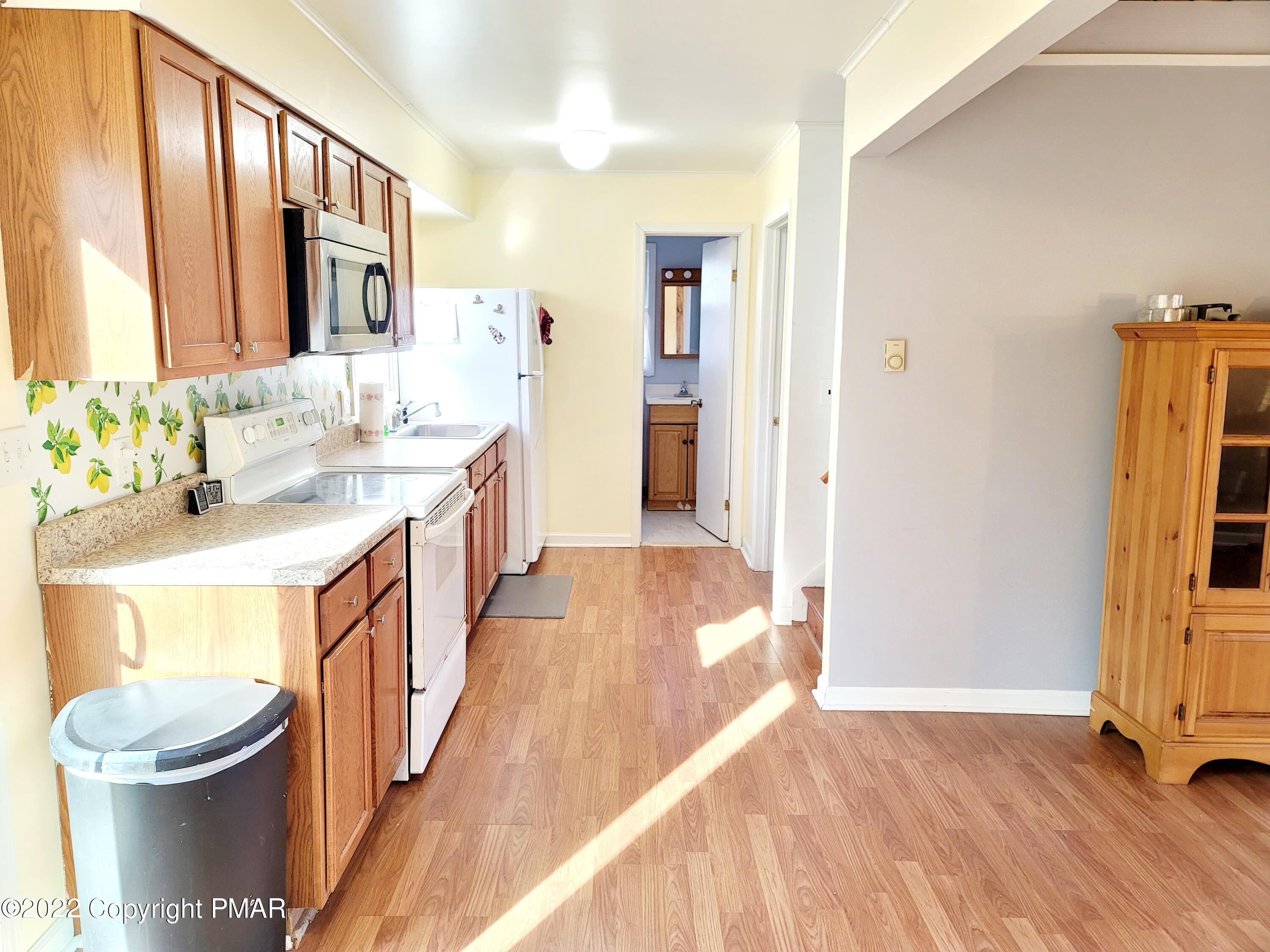 132 Rodeo Drive Hawley, PA 18428 - Photo 7 of 26 a bathroom with a sink a toilet and a mirror