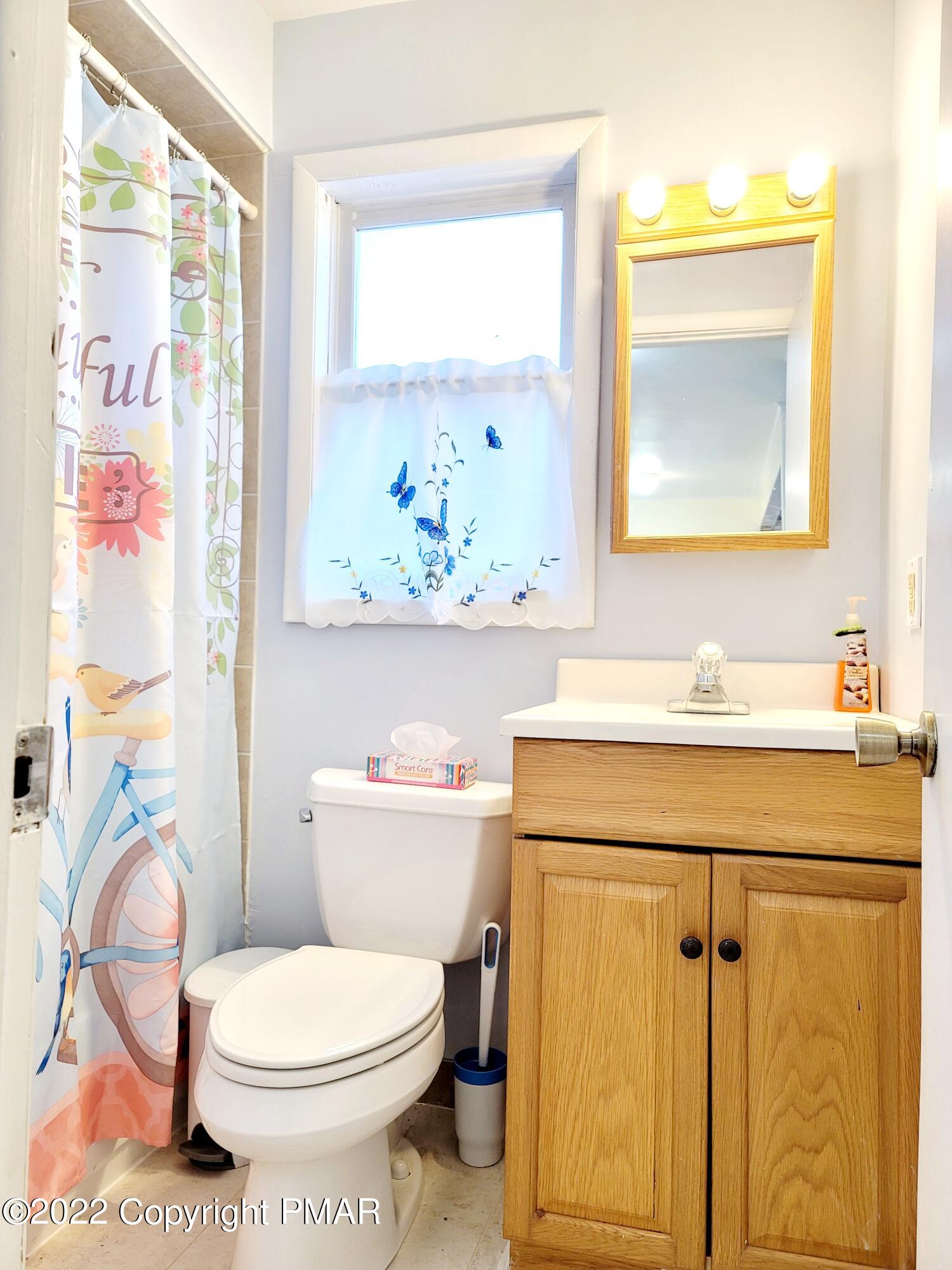 132 Rodeo Drive Hawley, PA 18428 - Photo 8 of 26 a bathroom with a sink toilet and mirror