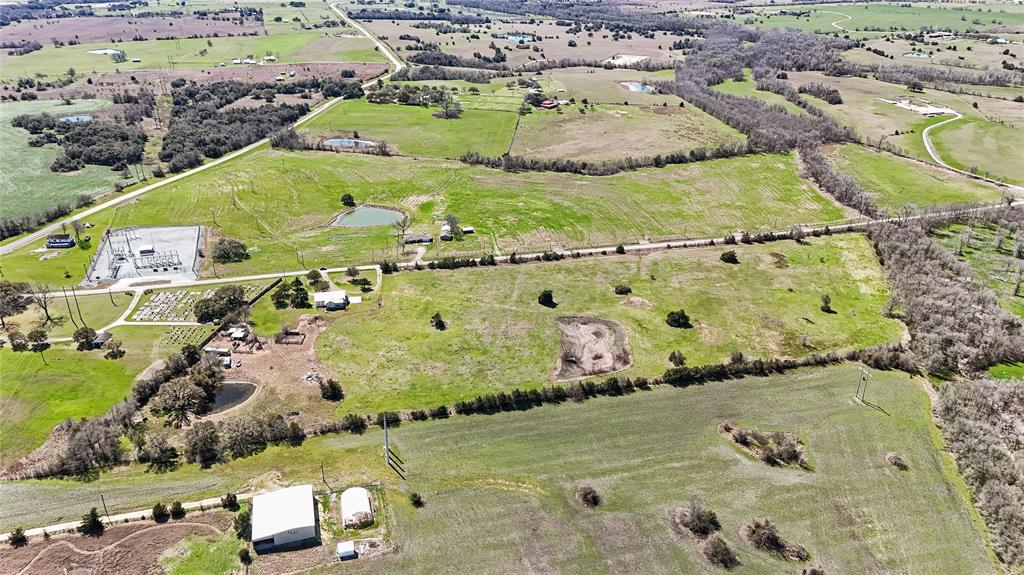 Aerial view of property and surrounding area featuring rural landscape