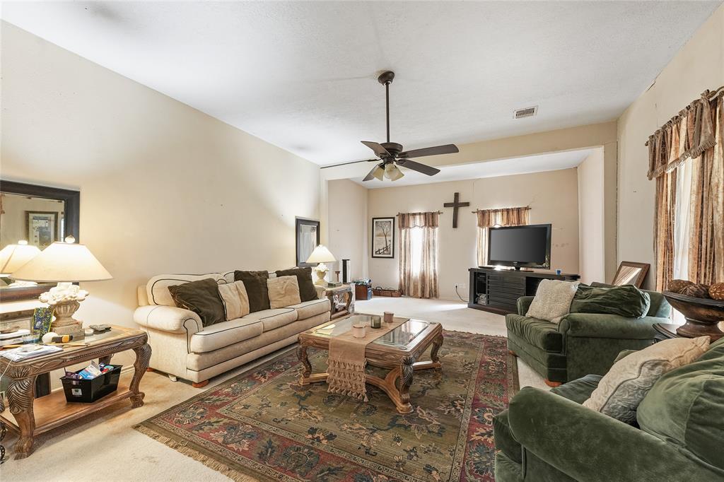 8515 Sandy Hill Road Brenham, TX 77833 - Photo 15 of 25 Living room featuring carpet, healthy amount of natural light, and a ceiling fan