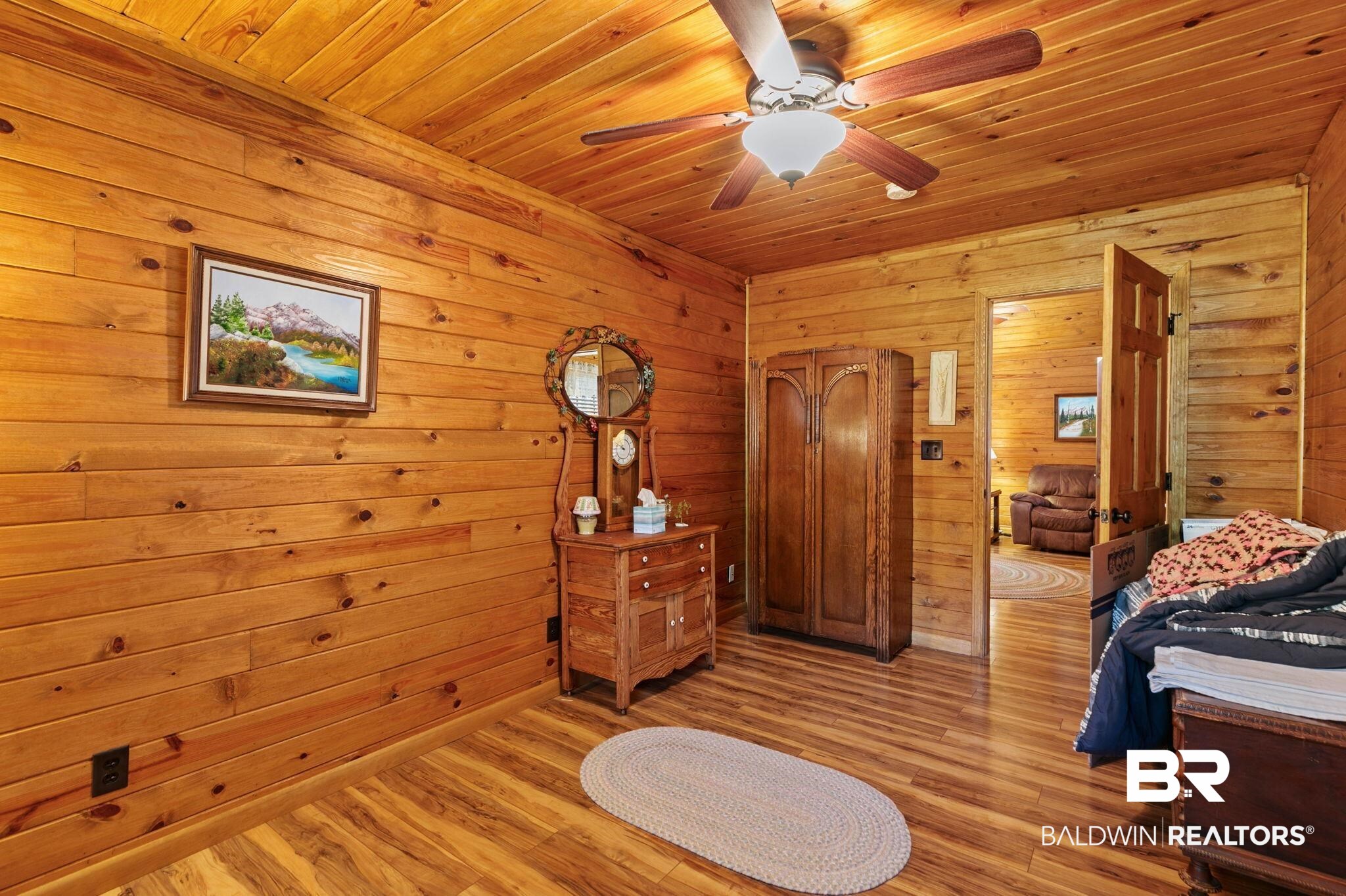 724 Rowell Lane Brewton, AL 36426 - Photo 27 of 40 Bedroom with wood ceiling, wood finished floors, wooden walls, and ceiling fan