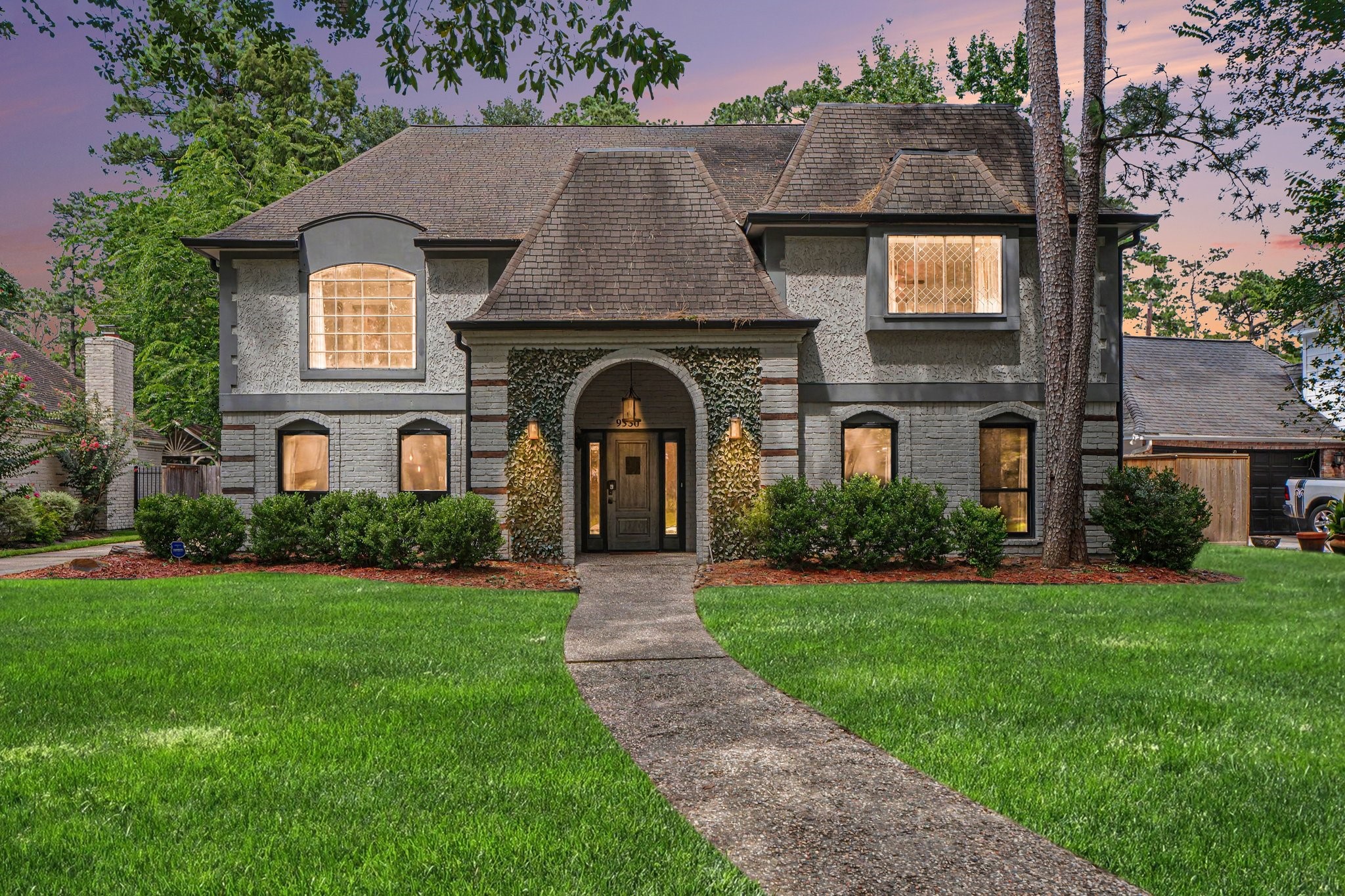 9530 Arcade Drive Spring, TX 77379 - Photo 3 of 32 Twilight view of this spectacular home! The front four lower windows have been upgraded with brand-new dual-pane windows!