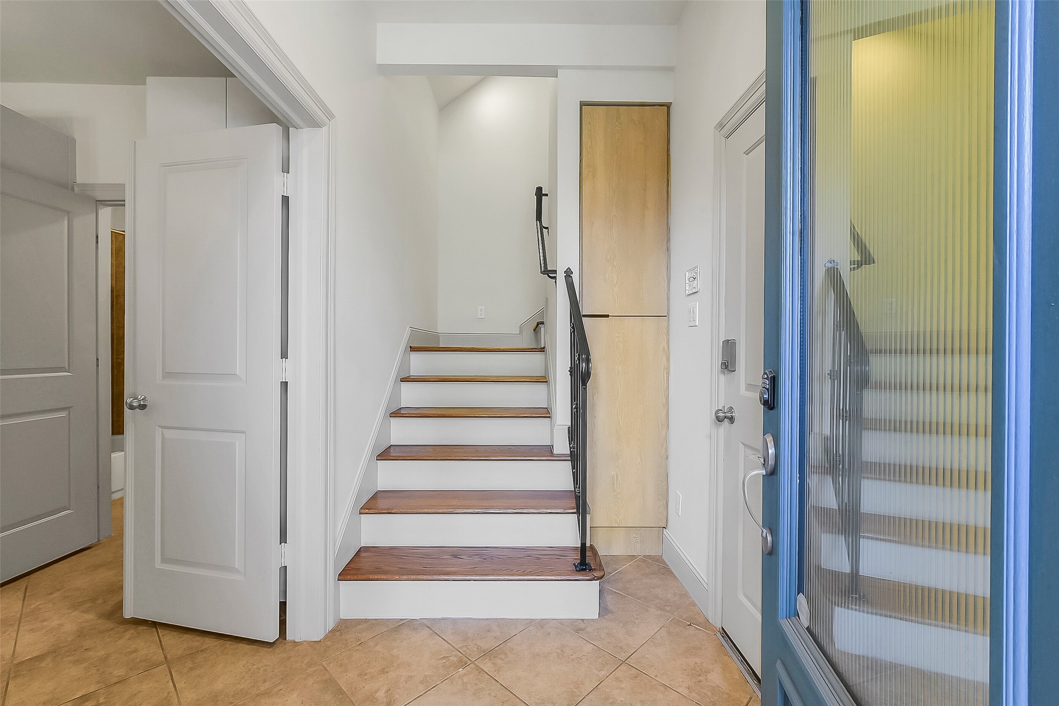 1929 Summer Street Houston, TX 77007 - Photo 7 of 27 Step inside to a welcoming entry with 9’ ceiling, a wooden front door with privacy glass. Built-in storage to the right of the stairs. Foyer provides direct access to the attached 2-car garage on the right and the first-floor secondary bedroom via French doors on the left.