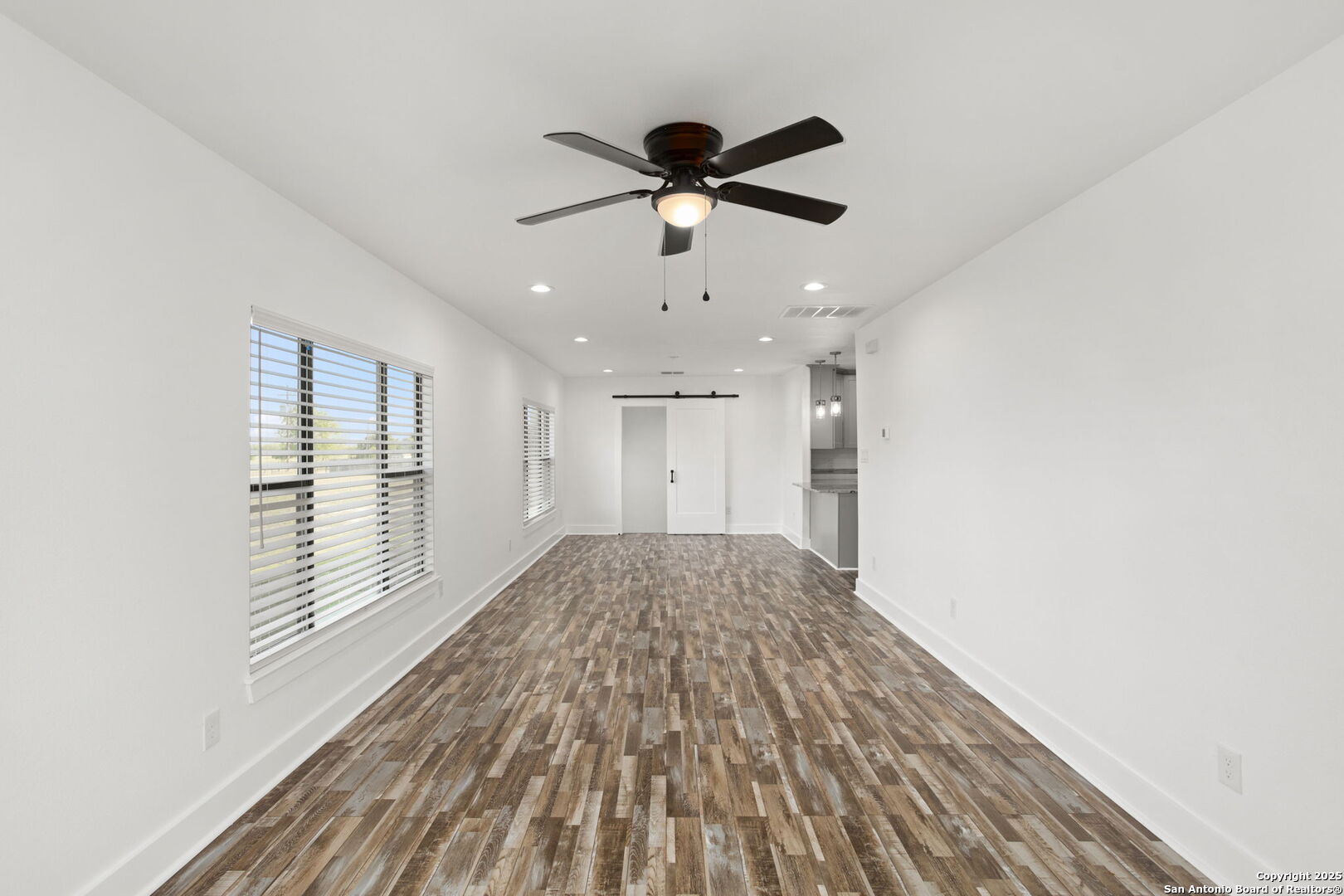 310 Creek Lane Poth, TX 78147 - Photo 11 of 32 a view of empty room with wooden floor and fan