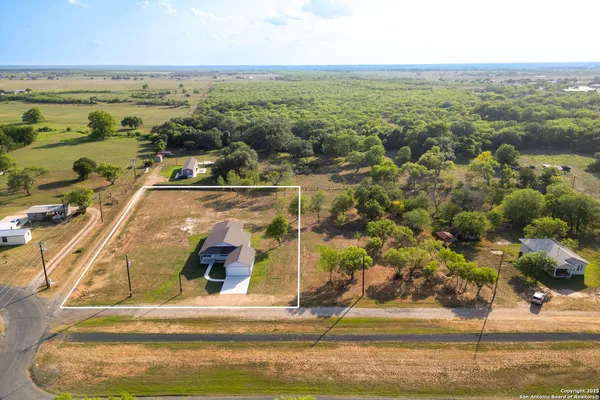 an aerial view of residential houses with outdoor space