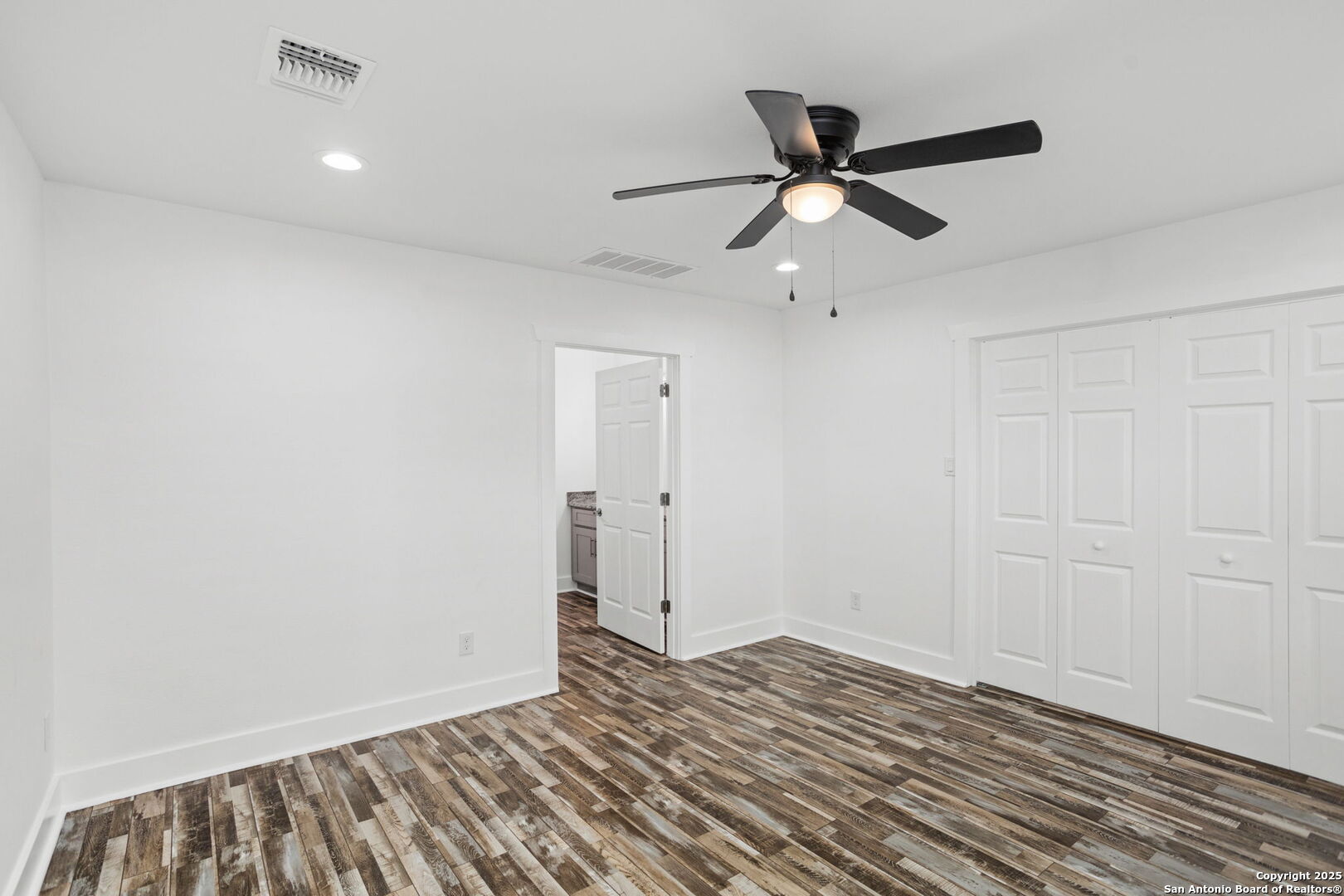 310 Creek Lane Poth, TX 78147 - Photo 18 of 32 a view of empty room with wooden floor and ceiling fan