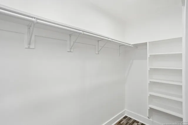 a utility room with granite countertop cabinets washer and dryer