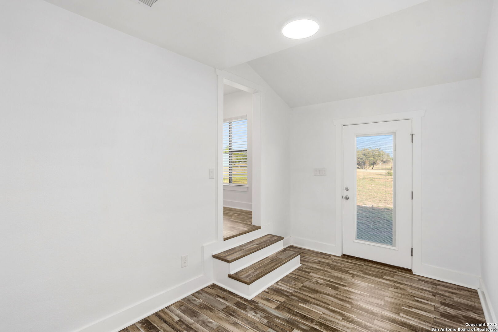 310 Creek Lane Poth, TX 78147 - Photo 26 of 32 an empty room with wooden floor and windows