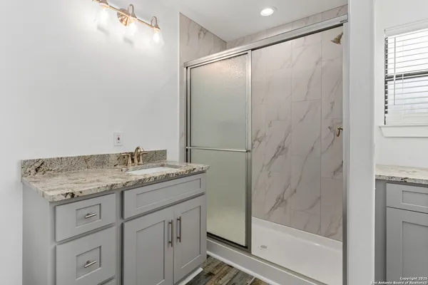 a bathroom with a granite countertop sink mirror and double