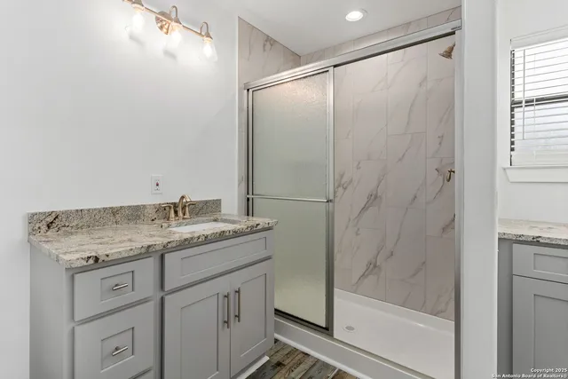 a bathroom with a granite countertop sink mirror and double