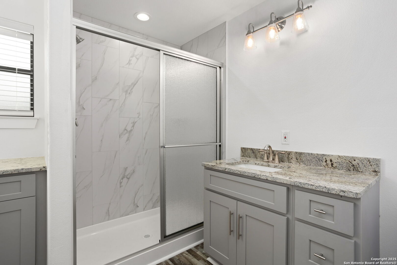 310 Creek Lane Poth, TX 78147 - Photo 30 of 32 a bathroom with a granite countertop sink mirror and double