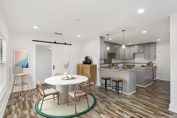a kitchen with stainless steel appliances granite countertop a sink stove and cabinets