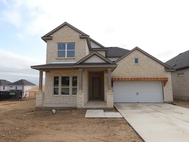 a front view of a house with a garage