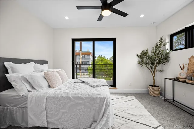 a bedroom with a large bed and a potted plant