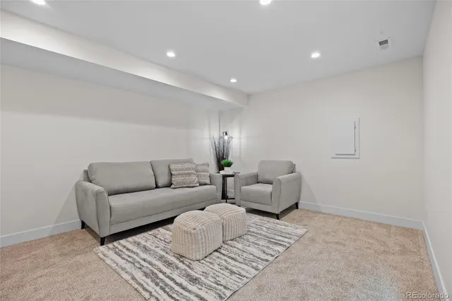 a living room with furniture and a lamp