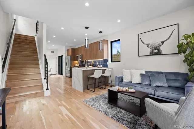 a living room with furniture and kitchen view