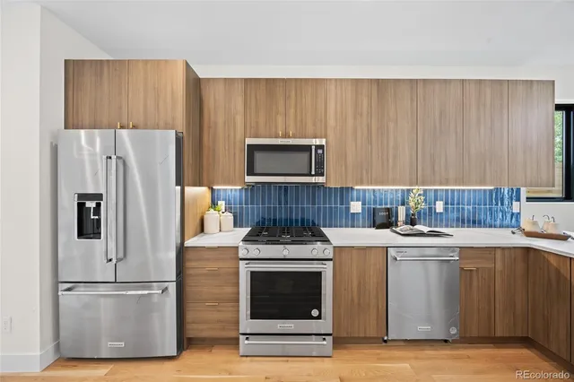 a kitchen with a stove and a refrigerator