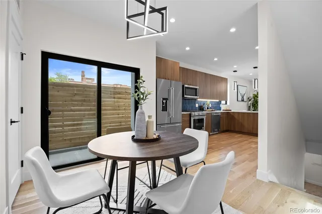 a kitchen with a table chairs and microwave
