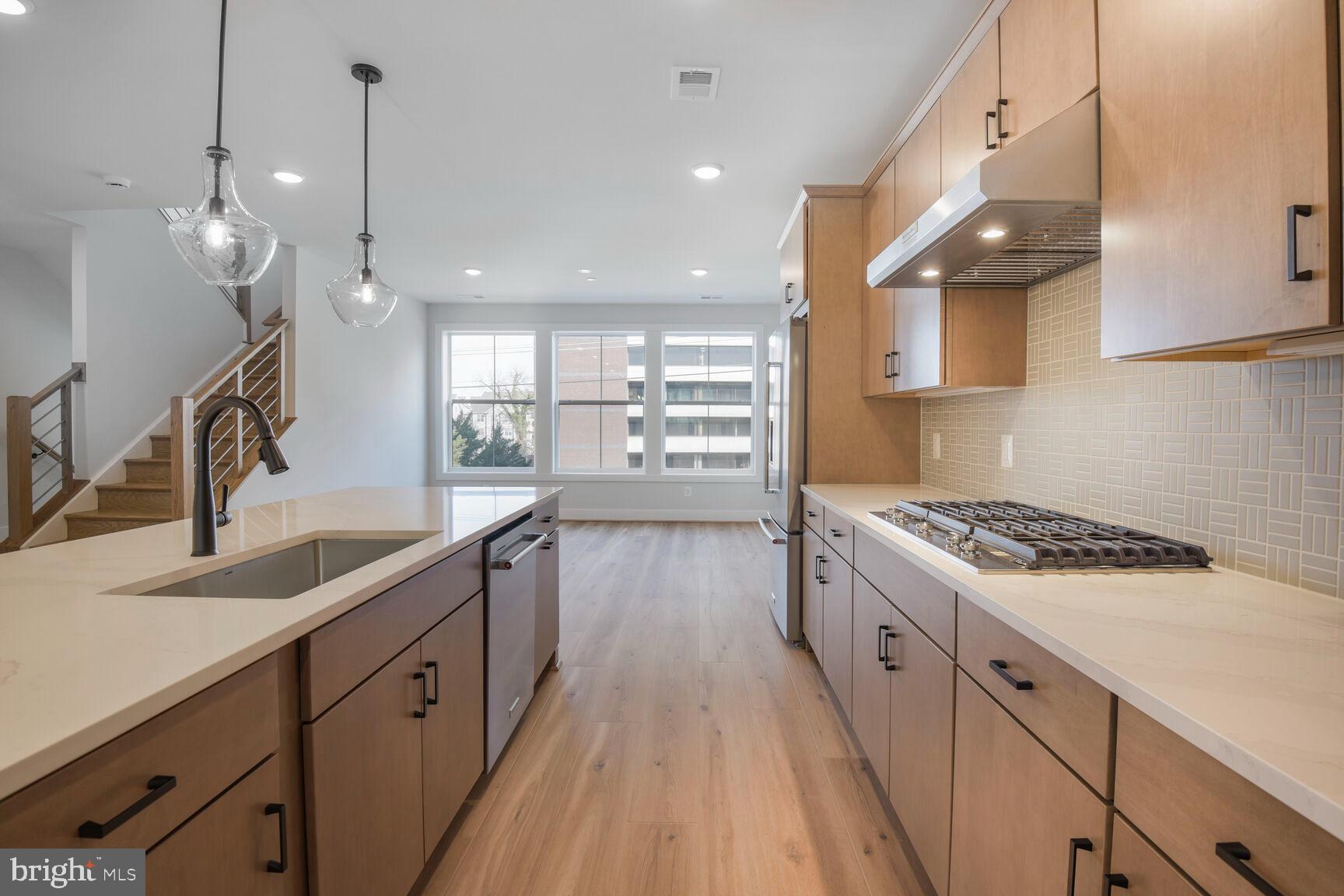 6020 Montrose Road North Bethesda, MD 20852 - Photo 12 of 27 a kitchen with granite countertop a sink a counter space appliances and cabinets