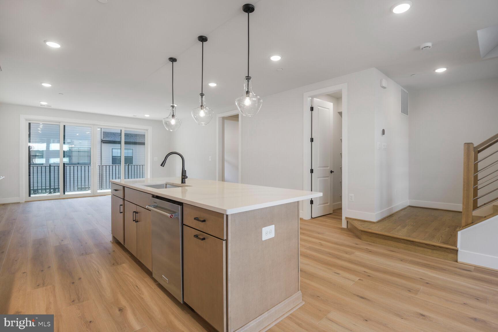 6020 Montrose Road North Bethesda, MD 20852 - Photo 13 of 27 a large kitchen with stainless steel appliances granite countertop a lot of counter space and wooden floors