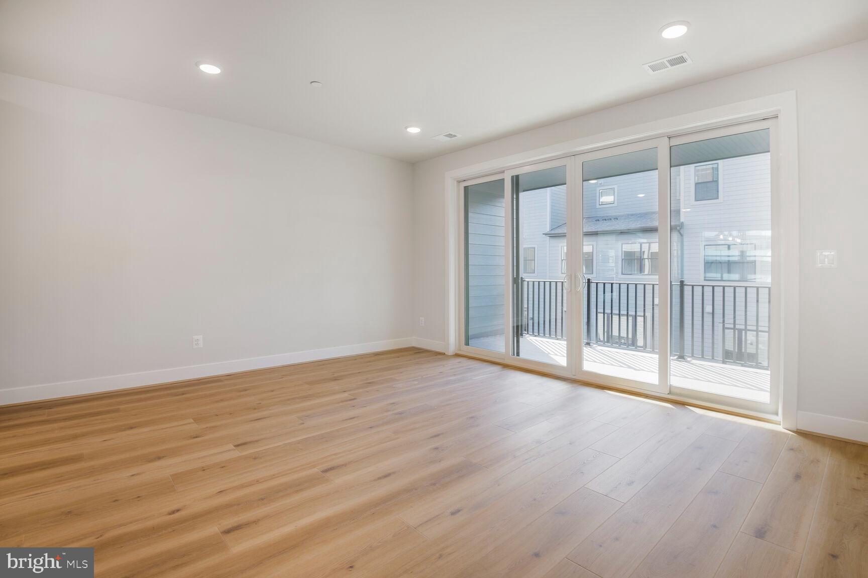 6020 Montrose Road North Bethesda, MD 20852 - Photo 16 of 27 a view of an empty room with wooden floor and a window