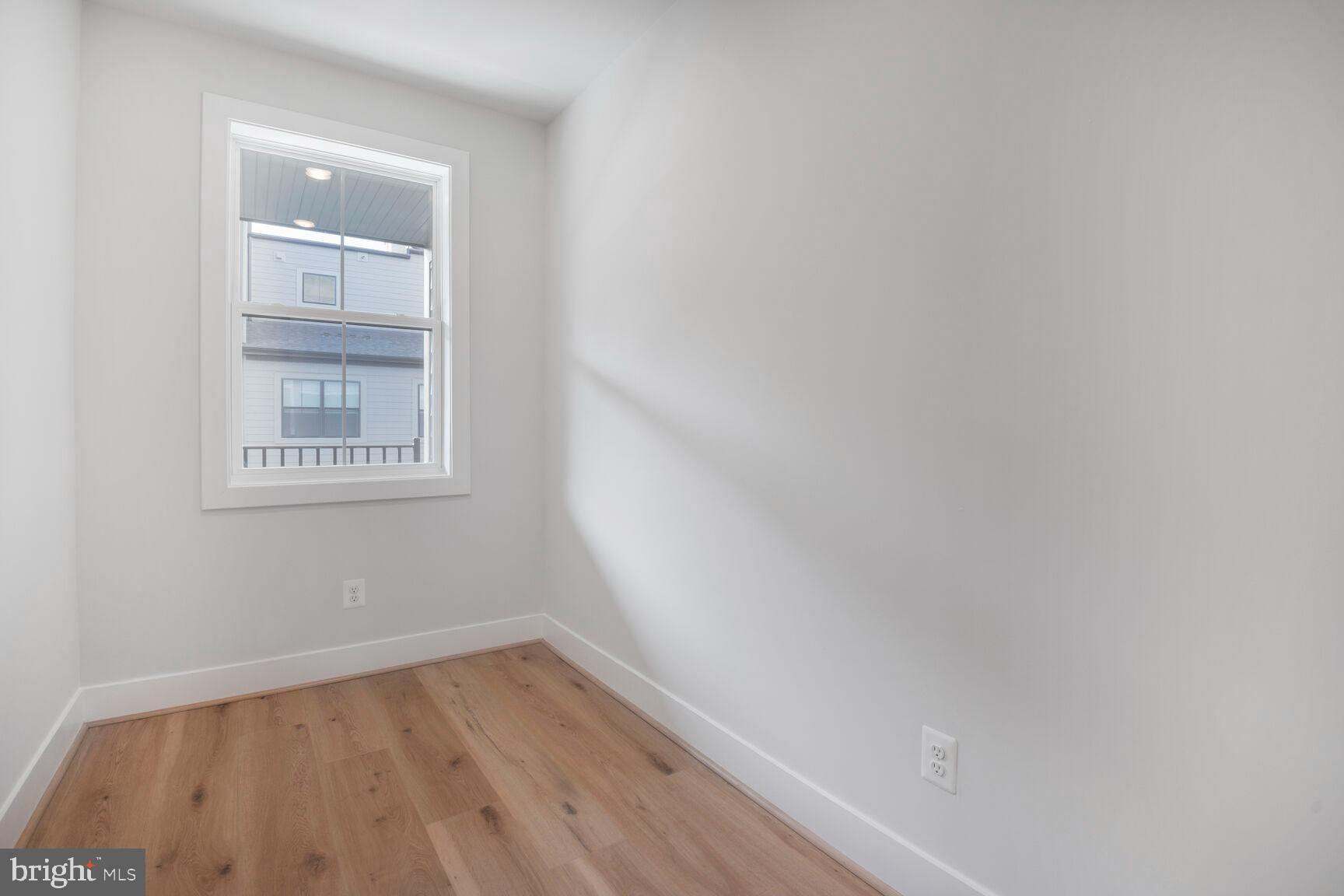 6020 Montrose Road North Bethesda, MD 20852 - Photo 20 of 27 a view of an empty room with wooden floor and a window