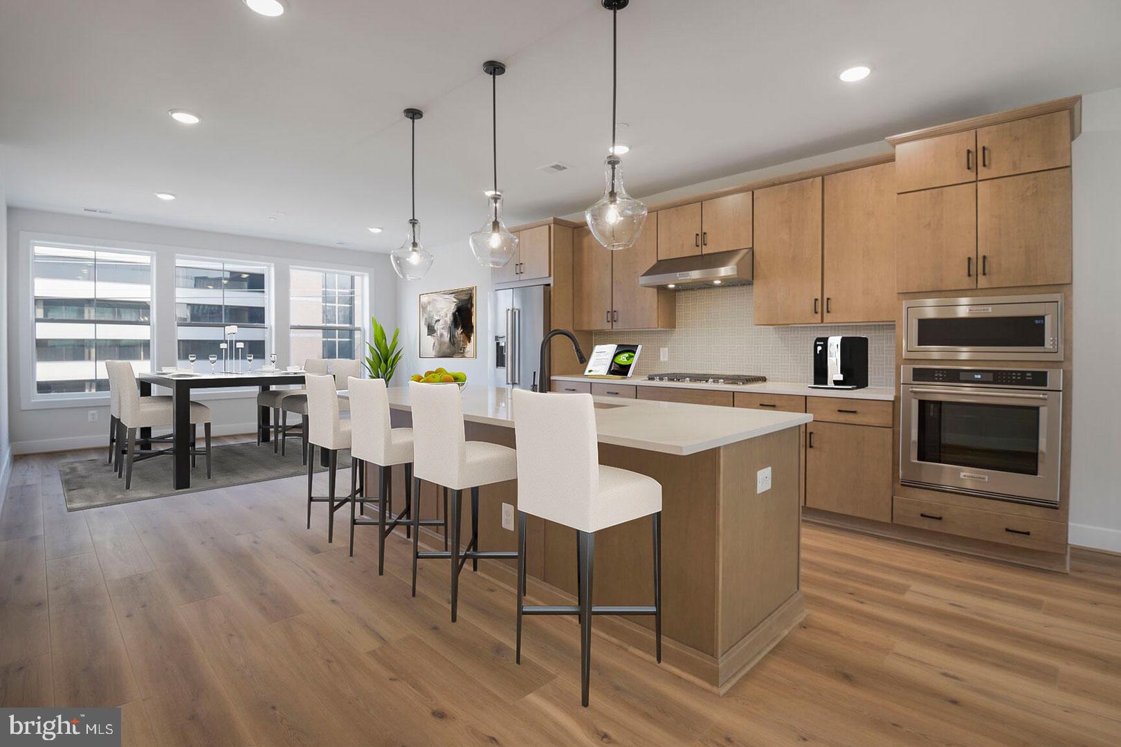 6020 Montrose Road North Bethesda, MD 20852 - Photo 2 of 27 a kitchen with stainless steel appliances kitchen island granite countertop a table chairs and a refrigerator