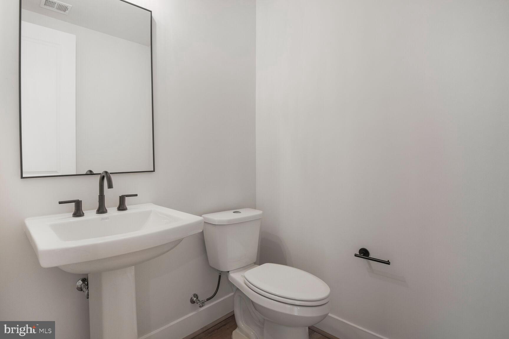 6020 Montrose Road North Bethesda, MD 20852 - Photo 23 of 27 a white toilet sitting next to a white sink