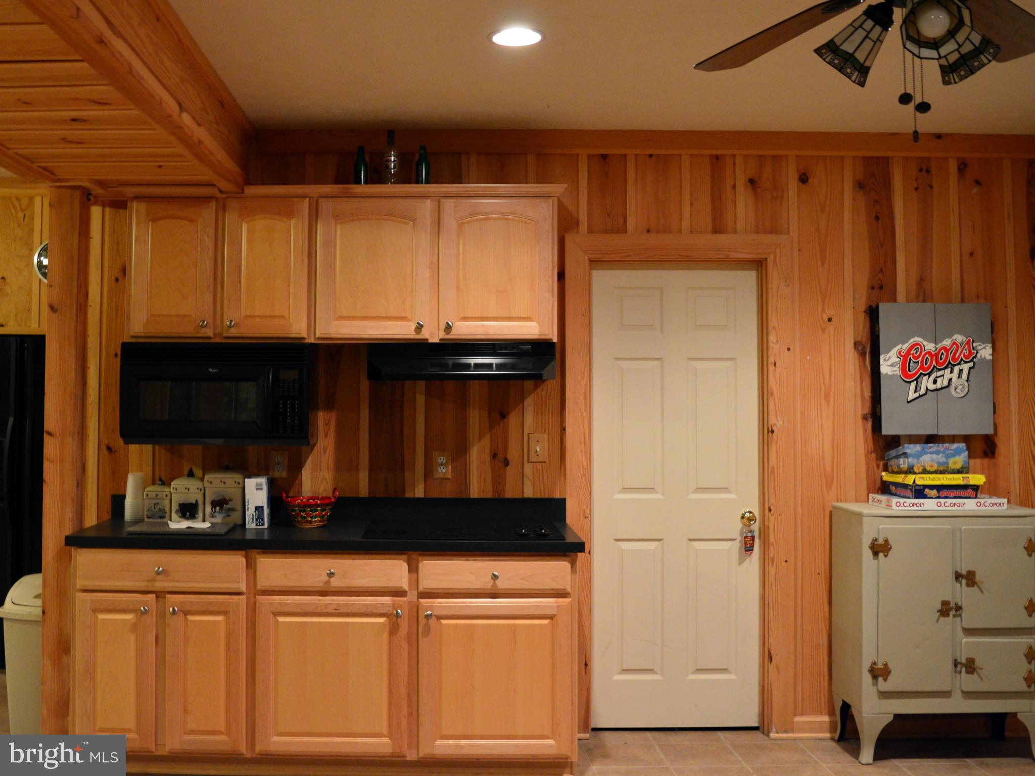 495 McCubbin Road Winchester, VA 22603 - Photo 22 of 29 a kitchen with stainless steel appliances wooden cabinets and a stove top oven