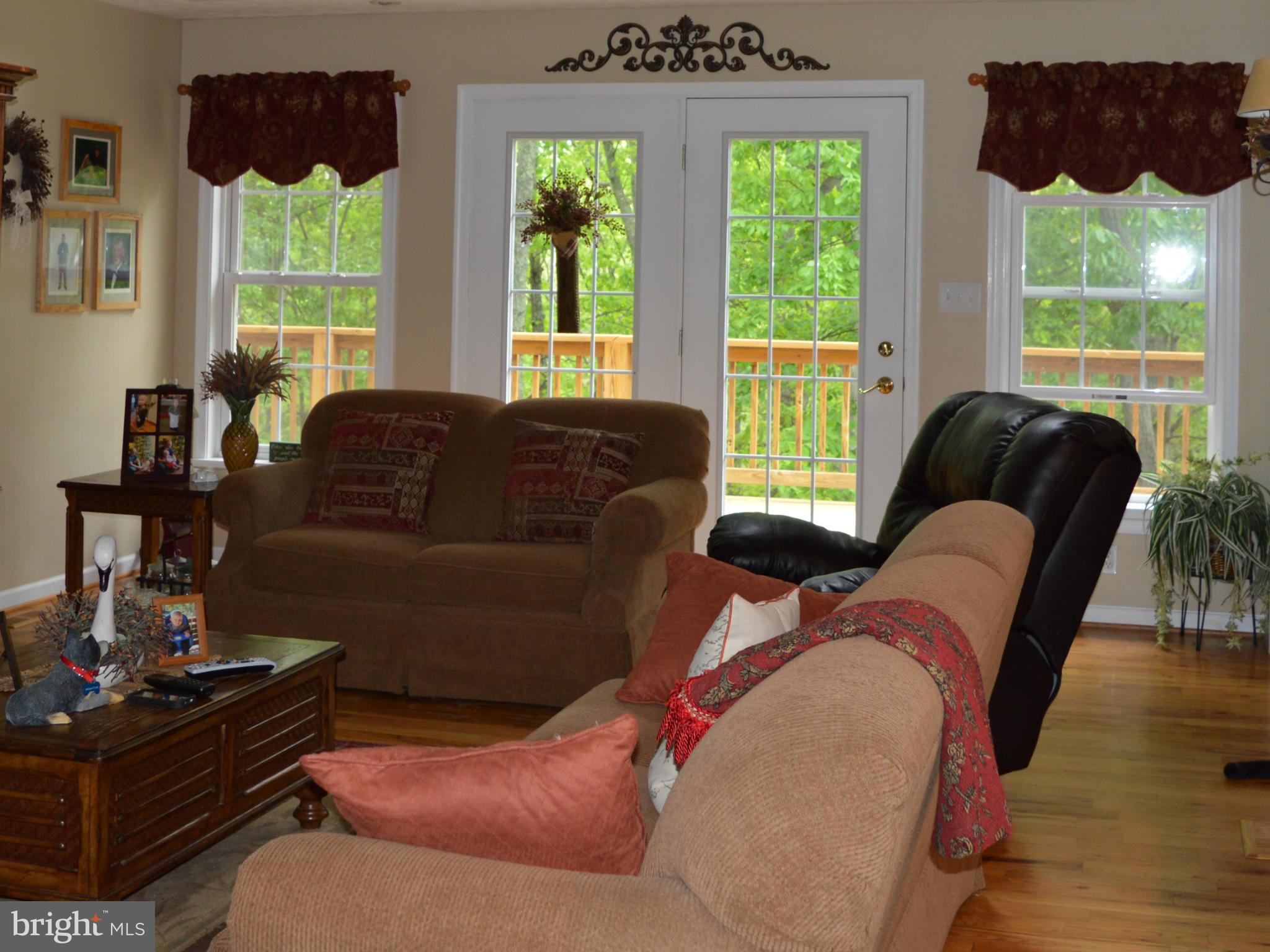 495 McCubbin Road Winchester, VA 22603 - Photo 5 of 29 a living room with furniture and a large window