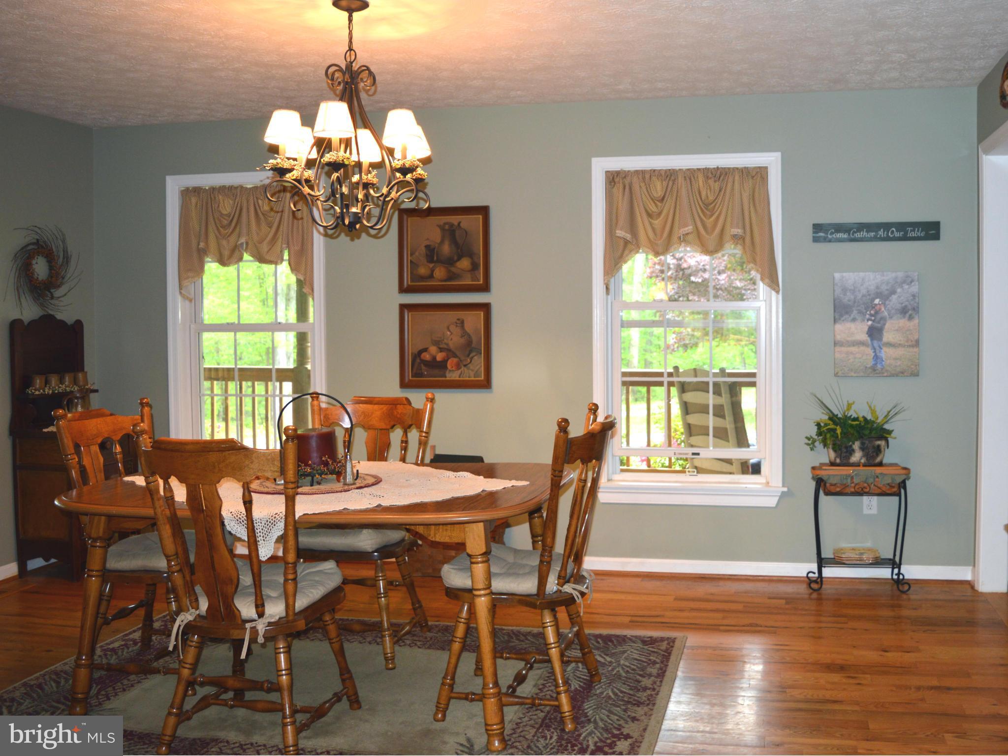 495 McCubbin Road Winchester, VA 22603 - Photo 7 of 29 a view of a dining room with furniture a chandelier and wooden floor