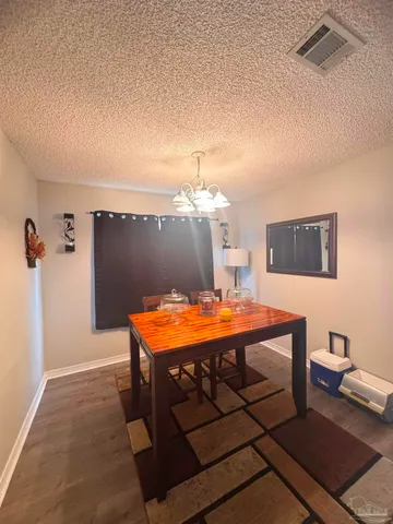 a dining room with a table and chairs