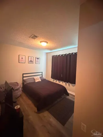 a bedroom with a bed and a closet