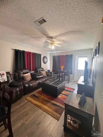 a living room with furniture a rug and a window
