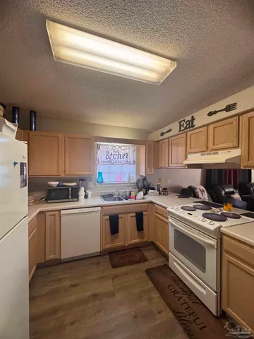 a kitchen with a stove top oven and sink