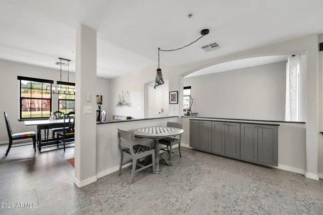 a dining room with furniture and window