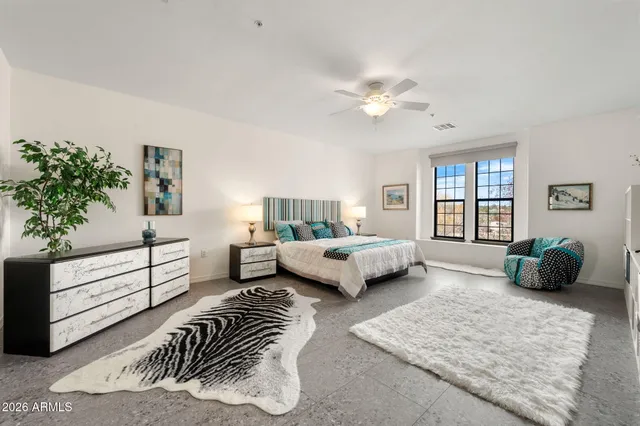 a bedroom with a bed and a couch