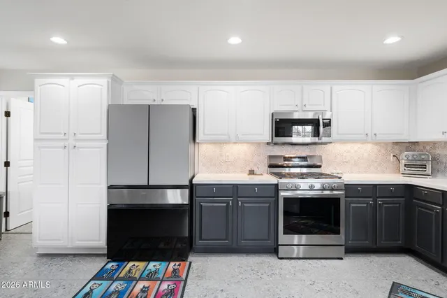 a kitchen with stainless steel appliances a stove a sink and a refrigerator