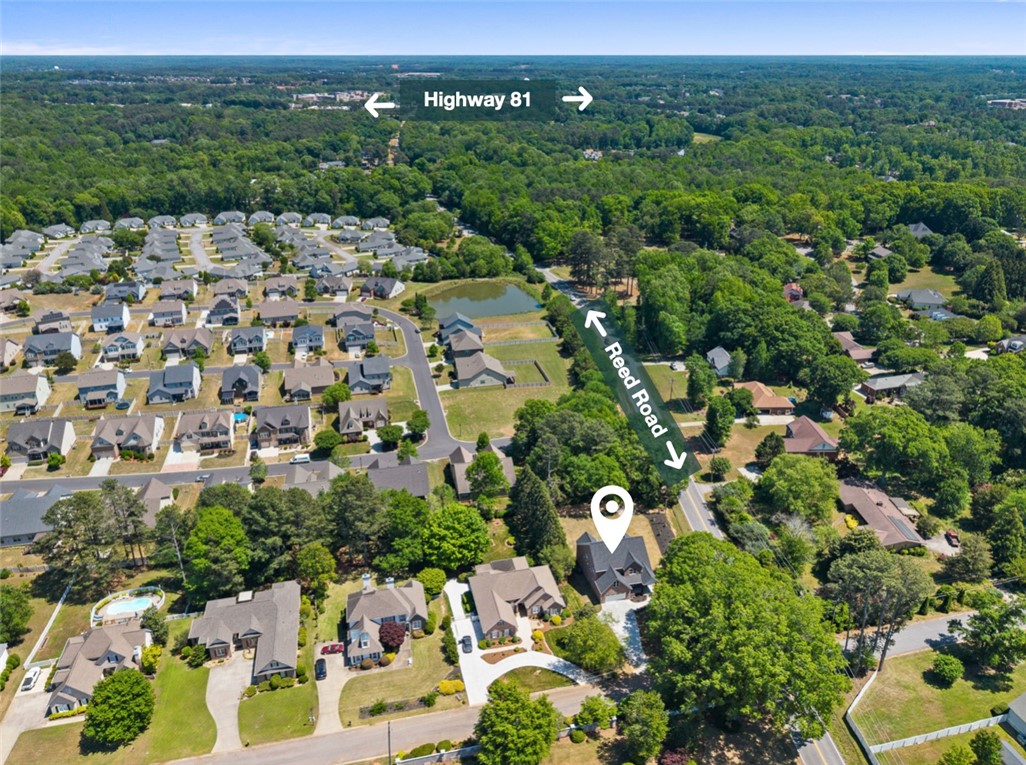 100 Garden Gate Drive Anderson, SC 29621 - Photo 42 of 43 An aerial view captures the neighborhood with a body of water and lush trees surrounding a home.