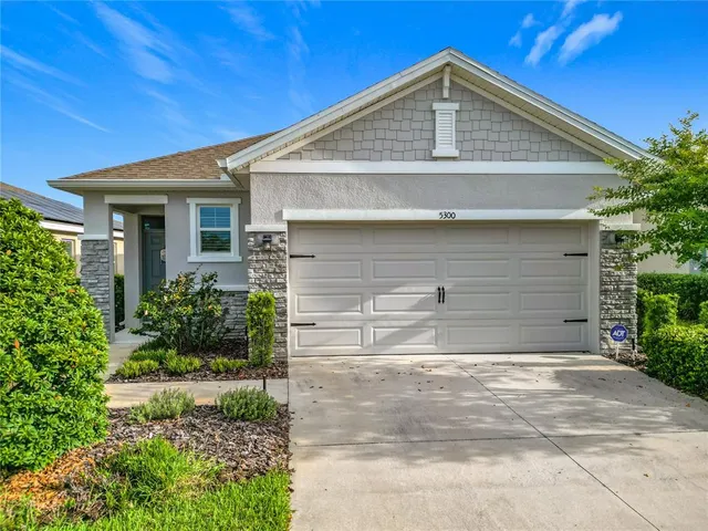a front view of a house with garage