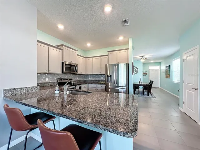 a kitchen with counter top space cabinets and stainless steel appliances