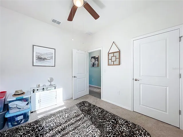 a view of a bedroom with baby crib and lounge chair
