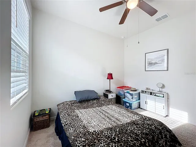 a bedroom that has a bed and a chandelier