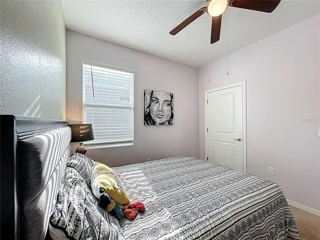 a bedroom with bed and a window