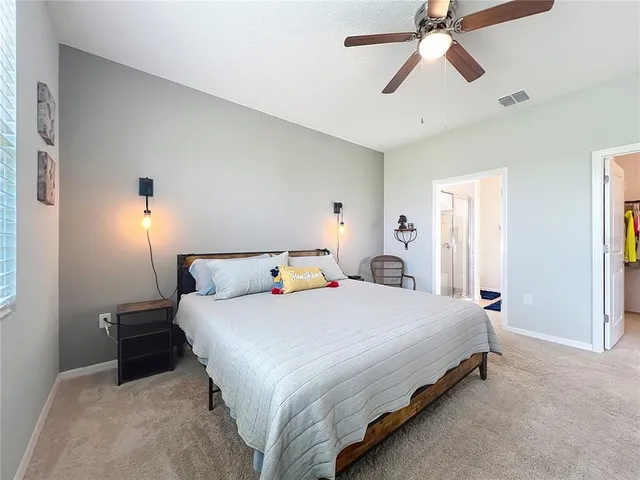 a bedroom with a bed and window