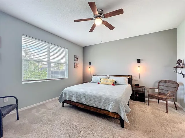 a bedroom with a bed and a chair