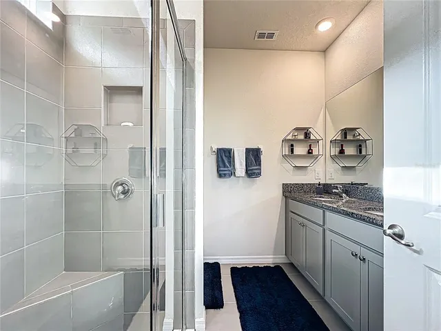 a kitchen with stainless steel appliances granite countertop a refrigerator and a stove