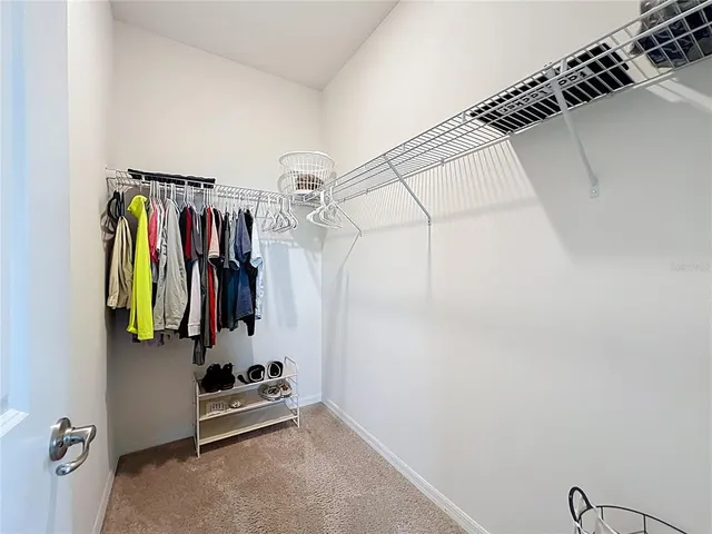 a view of walk in closet with clothes