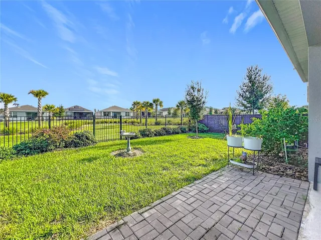a view of a garden with a building in the background